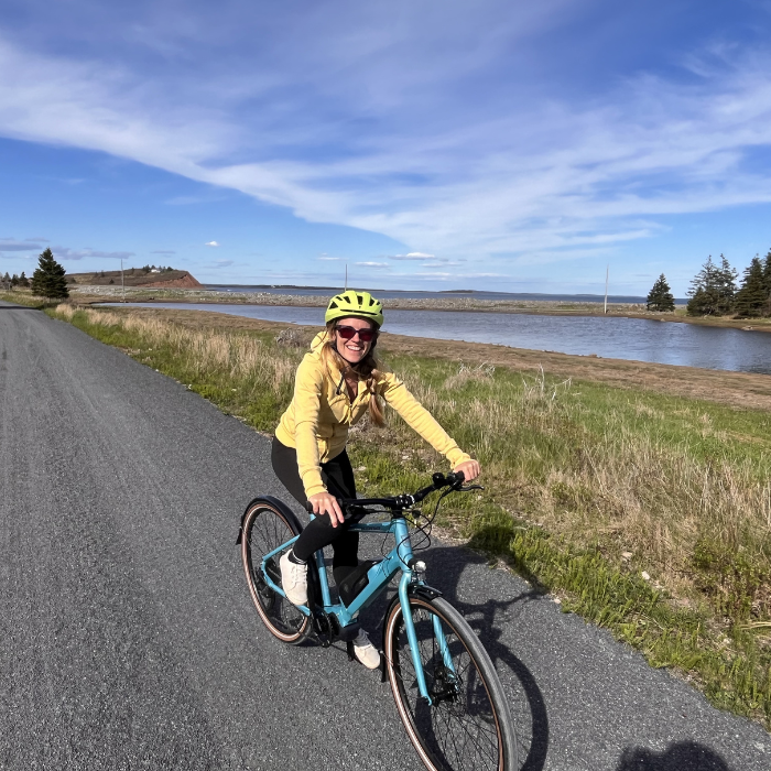 riding bike smiling on trail near lawerencetown beach Nova Scotia